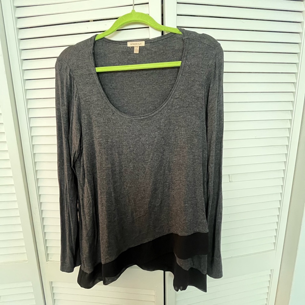 Grey and black long sleeve scoop neck top with asymmetrical front hem. Medium